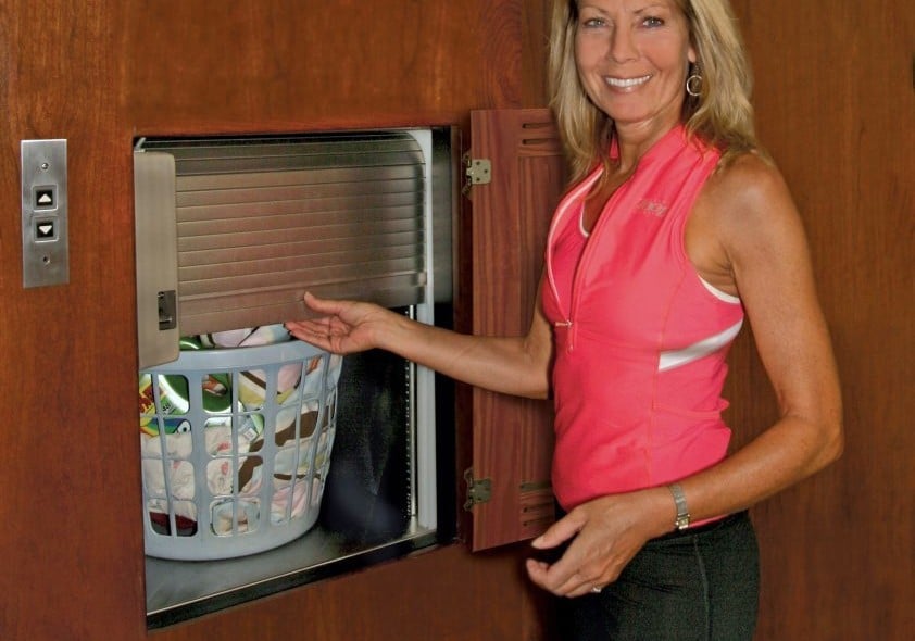 woman using dumbwaiter for laundry