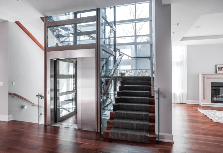 A glass elevator with metal trim